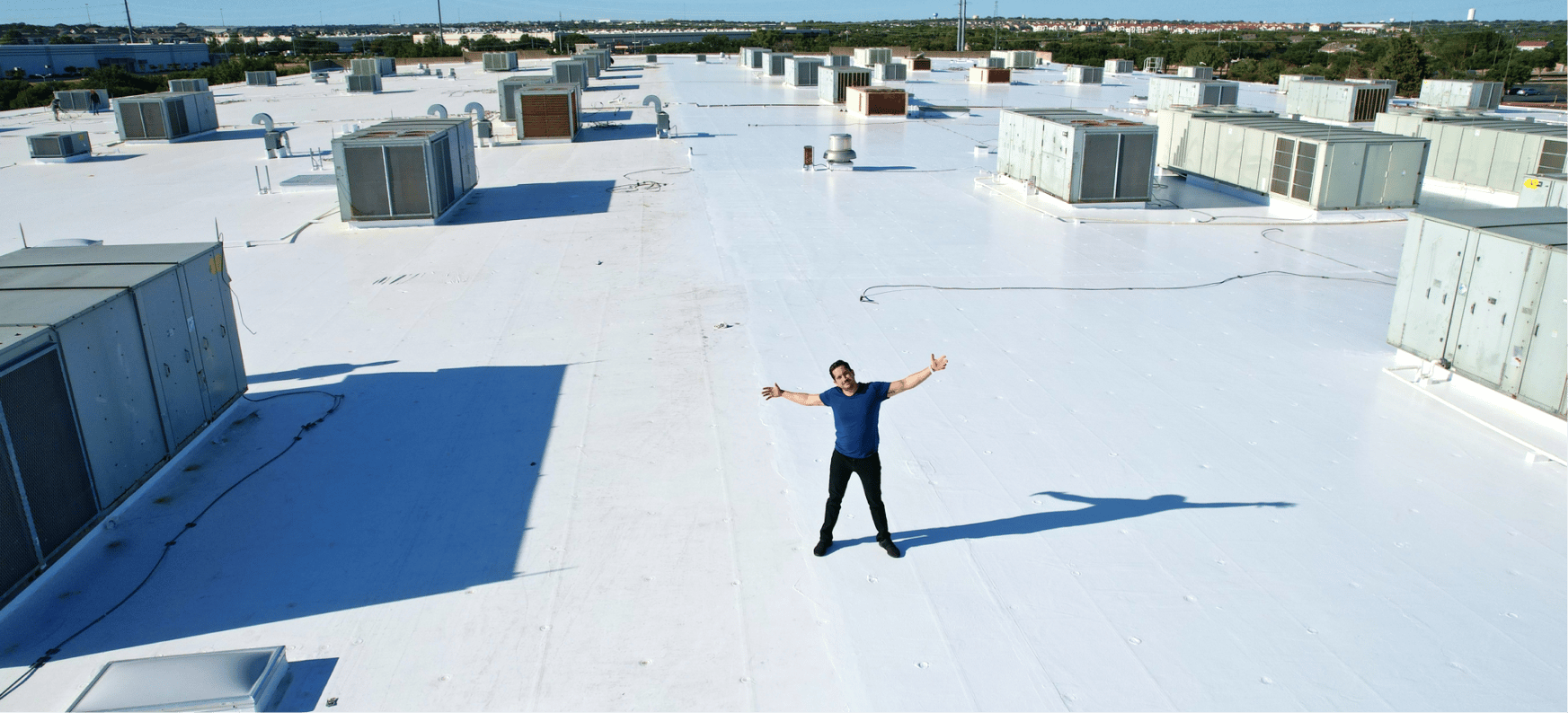  Pancho standing on large commercial roof.